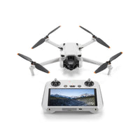 The DJI Mini 3 Drone with RC Controller in white with grey propellers on a white background. The RC is powered on, showing it's 5.5-inch FHD Screen. 